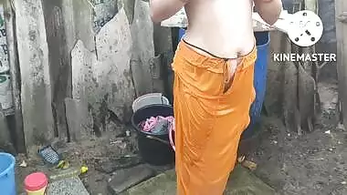 Indian house wife bathing outside