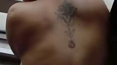Lady fucks in front of a transparent glass in Indian porn